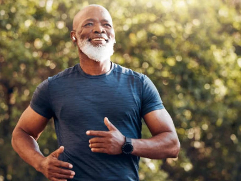 Man in his 50s looking tired and distracted, sitting alone